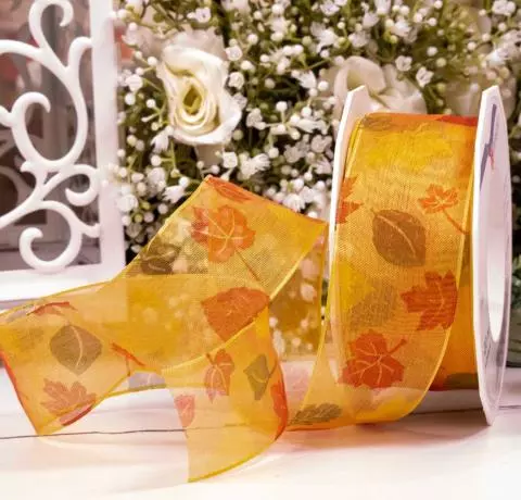 Autumn leaf print on orange sheer ribbon with wired edge 40mm
