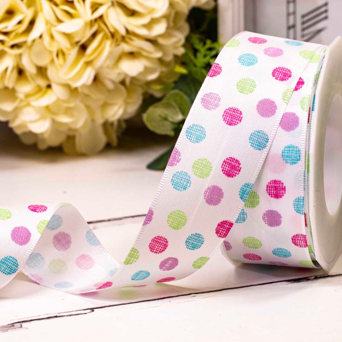 Multi coloured chalk style polka dot design on white 40mm wide taffeta ribbon